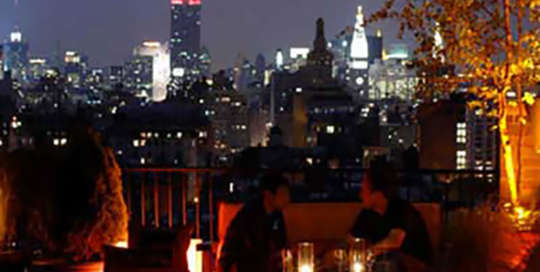 Thompson Hotel Rooftop at Dusk in NYC Empire State Building in Background