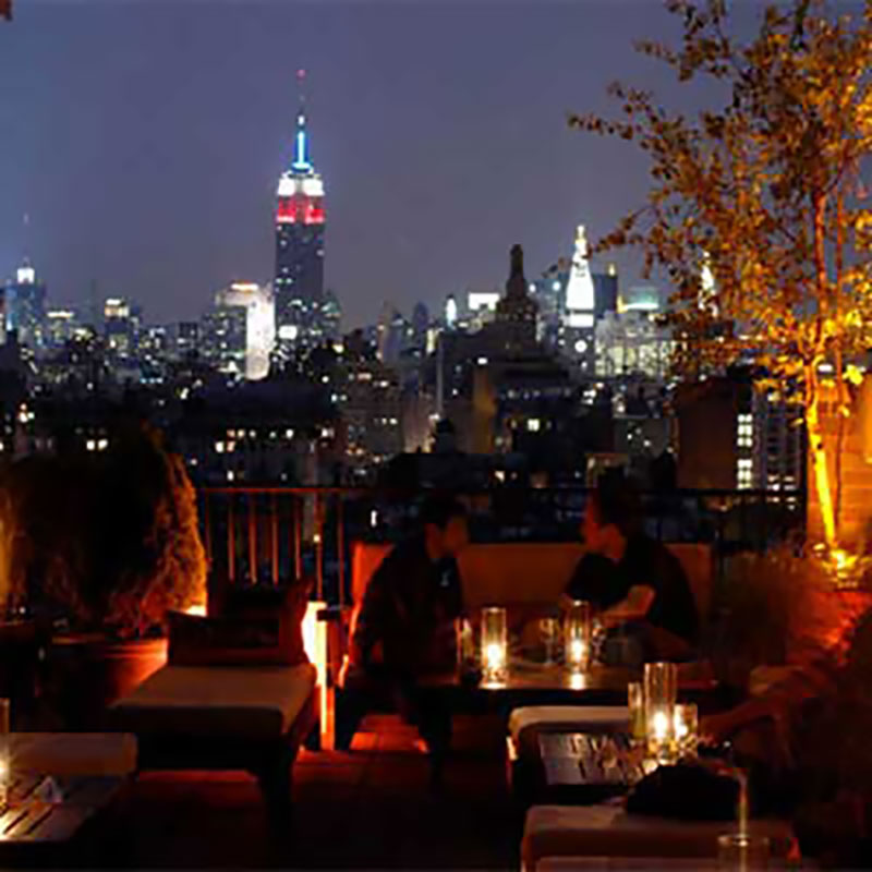 Thompson Hotel Rooftop at Dusk in NYC Empire State Building in Background