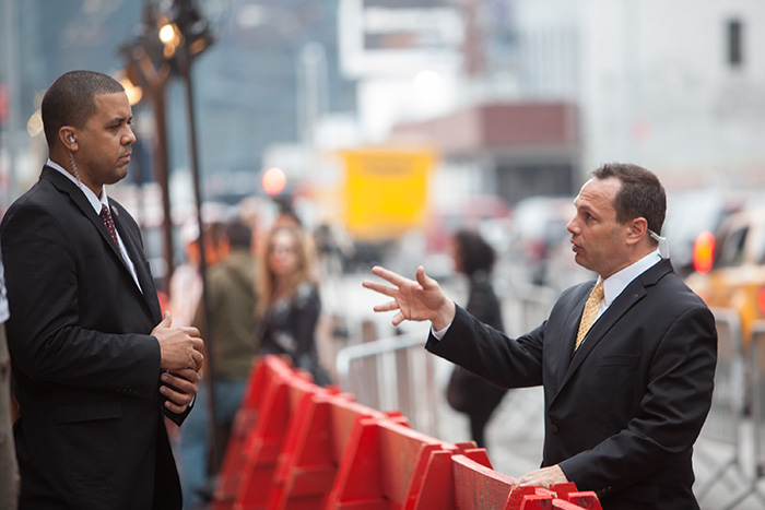 Film production security guards discussing a traffic closure