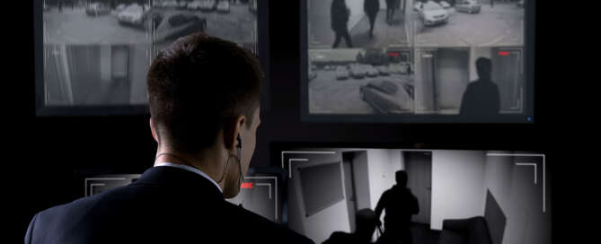 Building security guard monitoring CCTV cameras