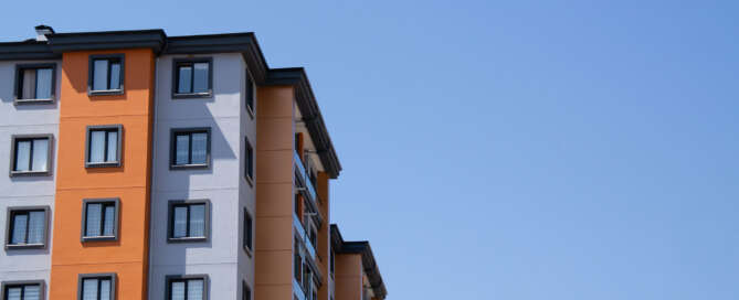 Exterior of an apartment building protected by a residential building security guard