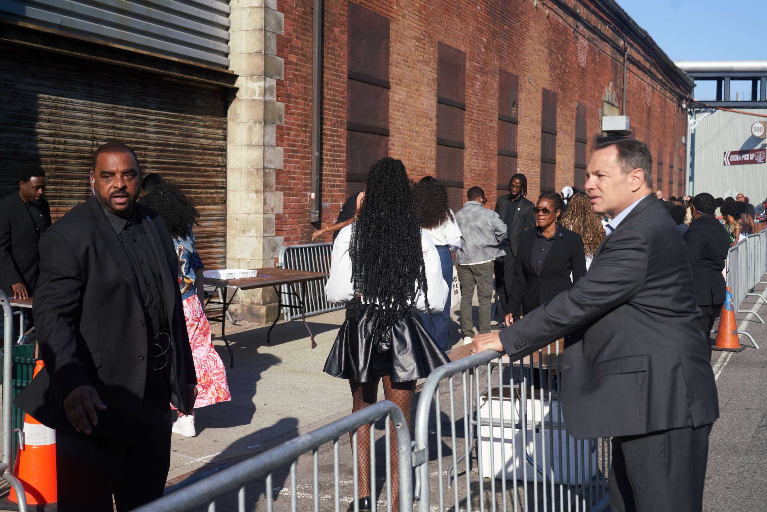 Security personnel manage a crowd at a high-profile event, ensuring safety and order in today's event environment.