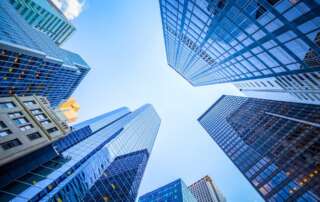 Looking up at buildings in New York City Financial District on a sunny day