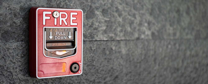 Fire alarm trigger mounted on the wall of an office building for fire safety